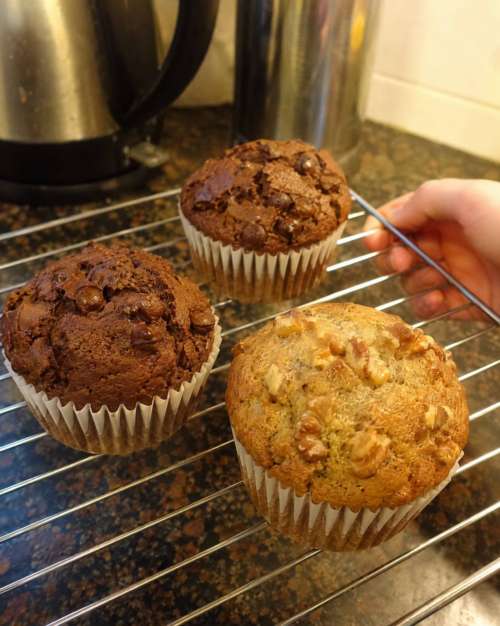 Banana walnut and double chocolate chip muffins on a cooling rack